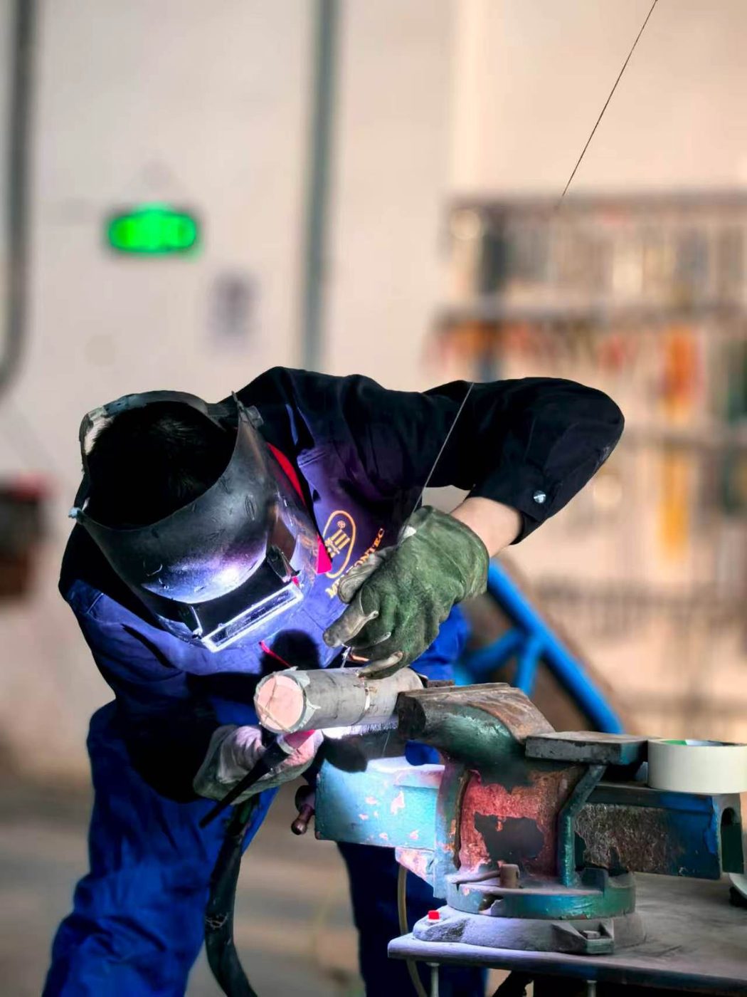 Qualified welder working on stainless steel pipe